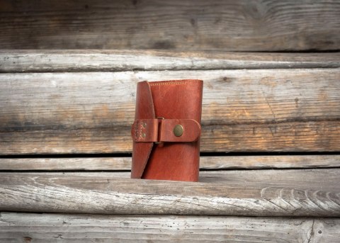 Wielofunkcyjny portfel w rudym kolorze wykonany z naturalnej skóry.